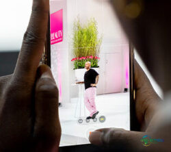 2024年BEAUTY Düsseldorf展台上，一人透过另一人的手机屏幕被看到；版权：Messe Düsseldorf/Andreas Wiese